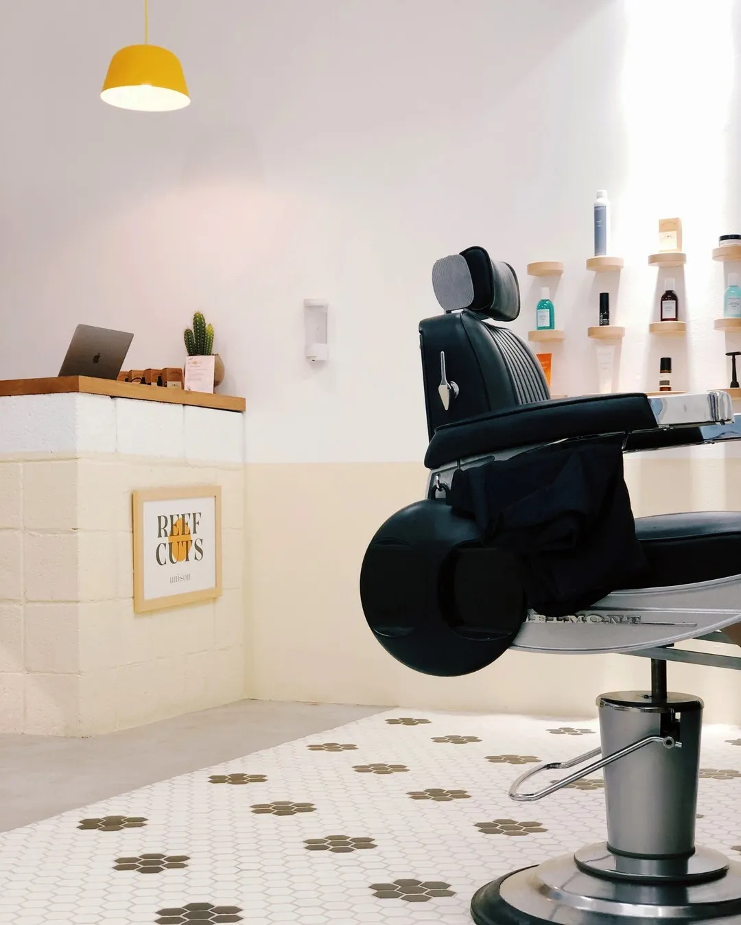 A barber chair on a tiled floor