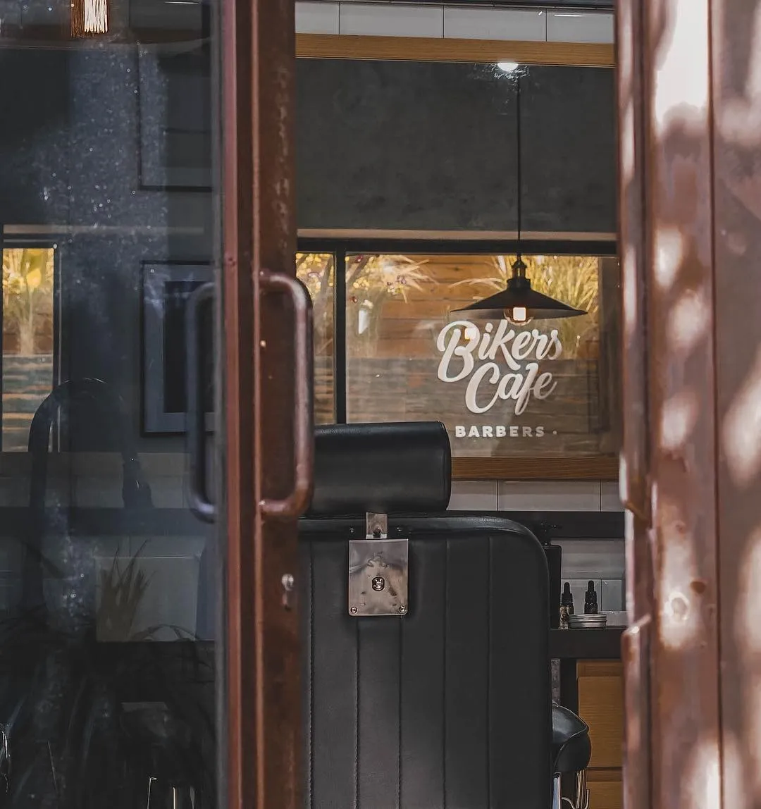 A rusted barbershop from the outside of the door